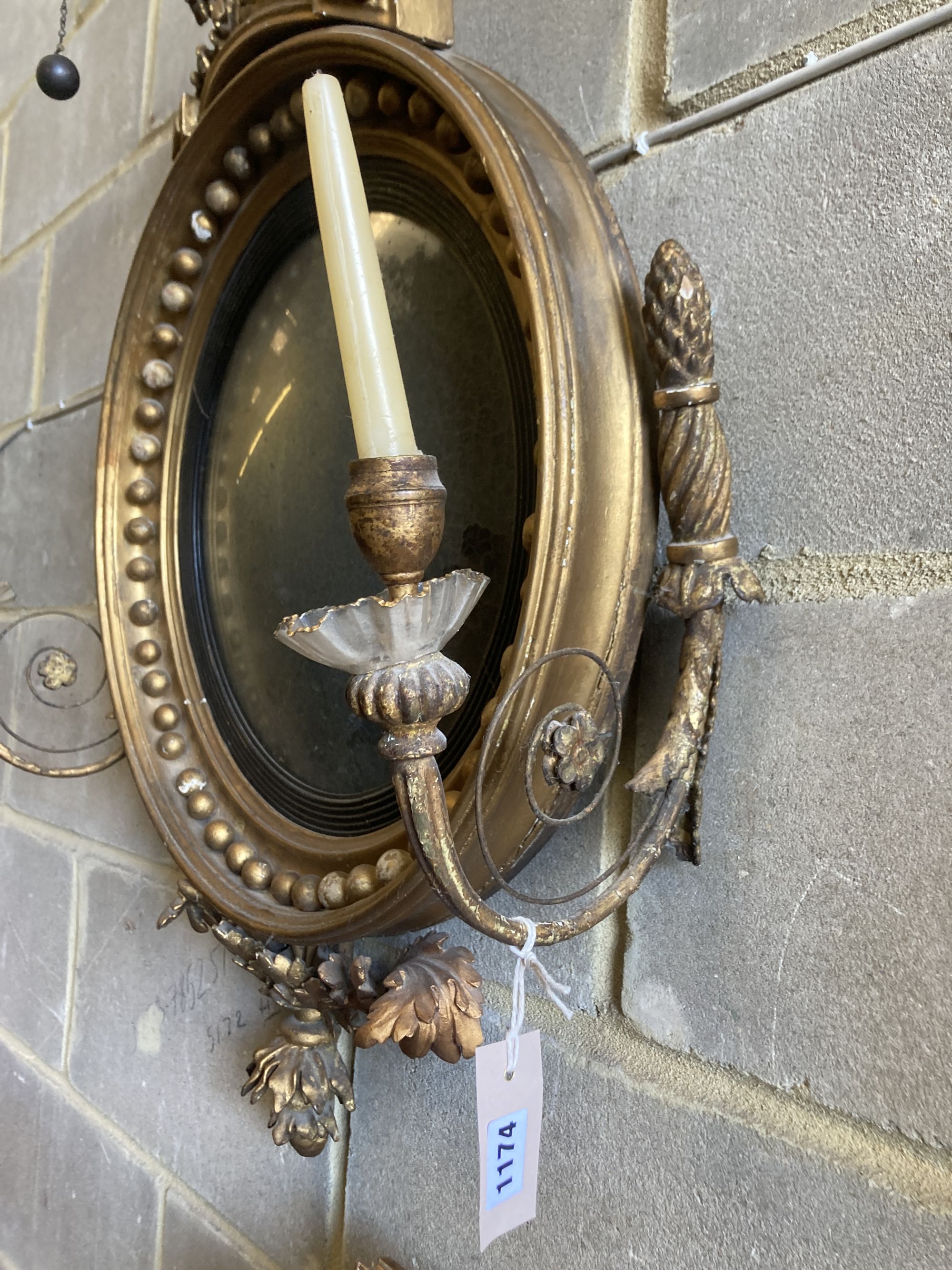 A Regency carved giltwood and gesso convex girandole wall mirror, width 65cm, height 90cm